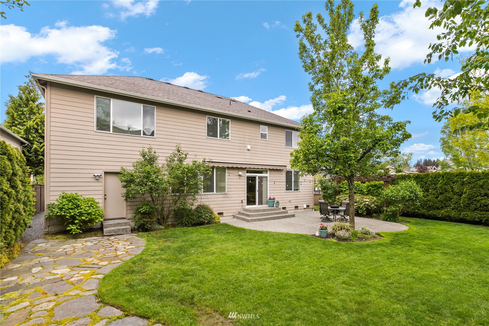 18407 36th Avenue Southeast Bothell, WA 98012 - Photo 32 of 39 a front view of a house with a garden and yard