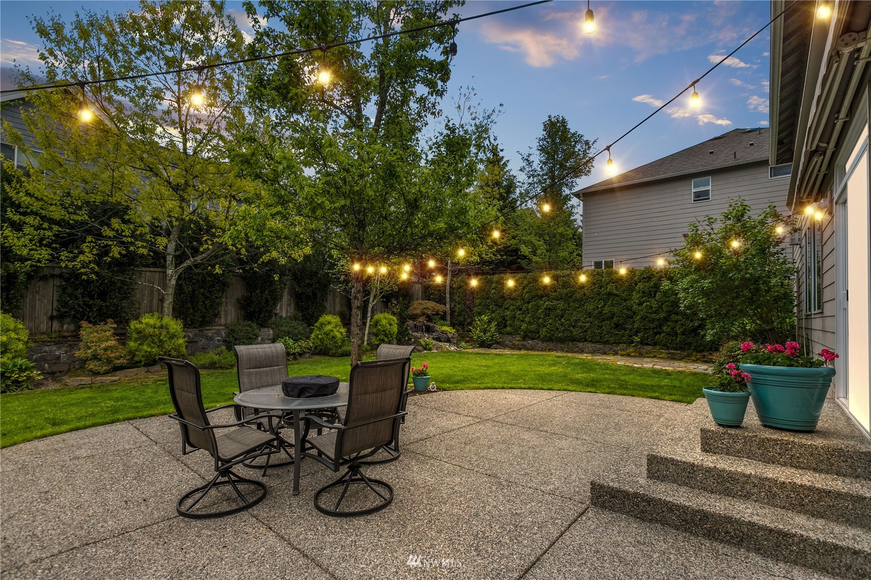 18407 36th Avenue Southeast Bothell, WA 98012 - Photo 35 of 39 a view of a table and chairs in back yard of the house