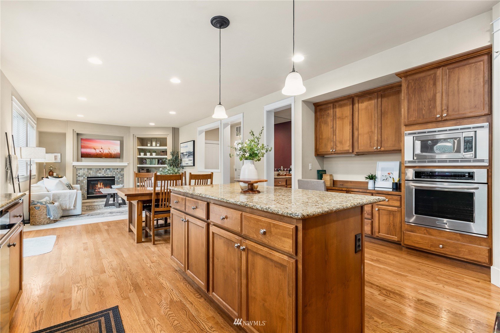 18407 36th Avenue Southeast Bothell, WA 98012 - Photo 10 of 39 a kitchen with stainless steel appliances granite countertop a stove top oven a sink dishwasher a dining table and chairs with wooden floor