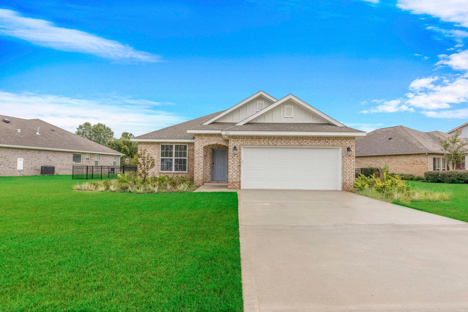 525 Windchime Way Freeport, FL 32439 - Photo 1 of 59 a front view of a house with a yard