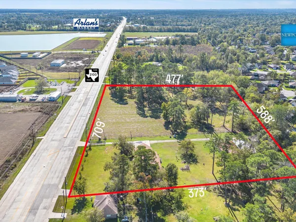 a front view of a house with a garden and yard