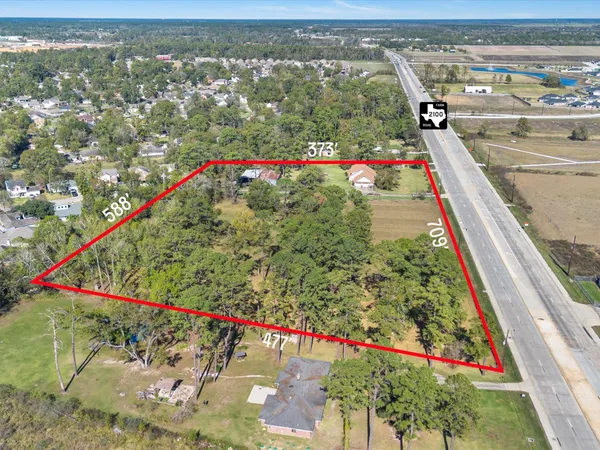 a view of a house with a yard and potted plants