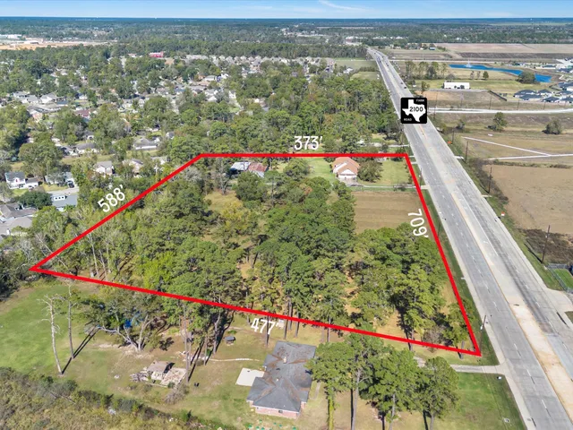 a view of a house with a yard and potted plants
