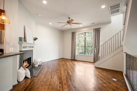 a kitchen with stainless steel appliances granite countertop a sink a stove and a wooden floors