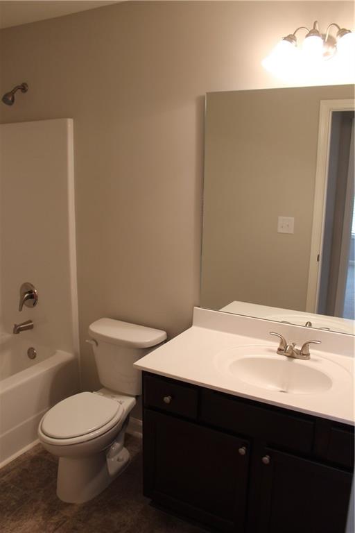 4741 Beacon Ridge Lane Flowery Branch, GA 30542 - Photo 11 of 15 a bathroom with a sink a toilet and shower