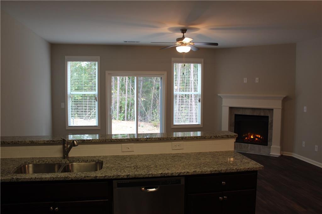 4741 Beacon Ridge Lane Flowery Branch, GA 30542 - Photo 3 of 15 a kitchen with granite countertop a sink stainless steel appliances and a window