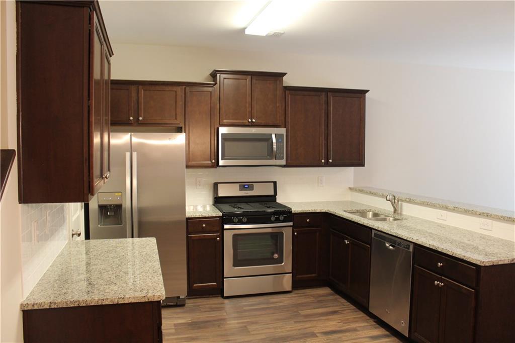 4741 Beacon Ridge Lane Flowery Branch, GA 30542 - Photo 5 of 15 a kitchen with a sink stove and refrigerator