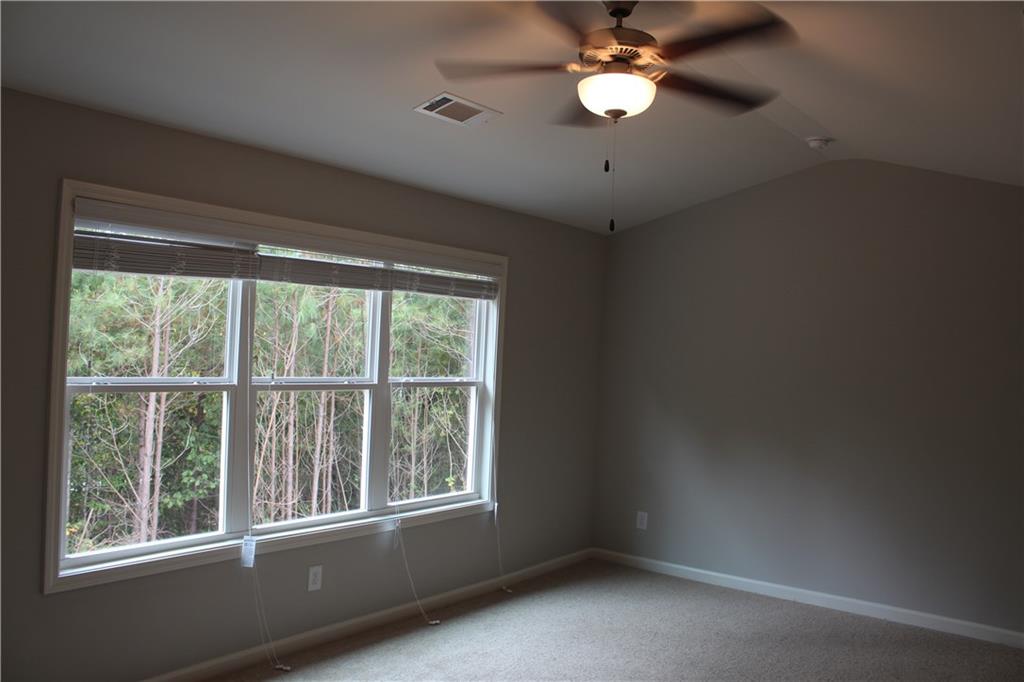 4741 Beacon Ridge Lane Flowery Branch, GA 30542 - Photo 8 of 15 an empty room with a window and a fan