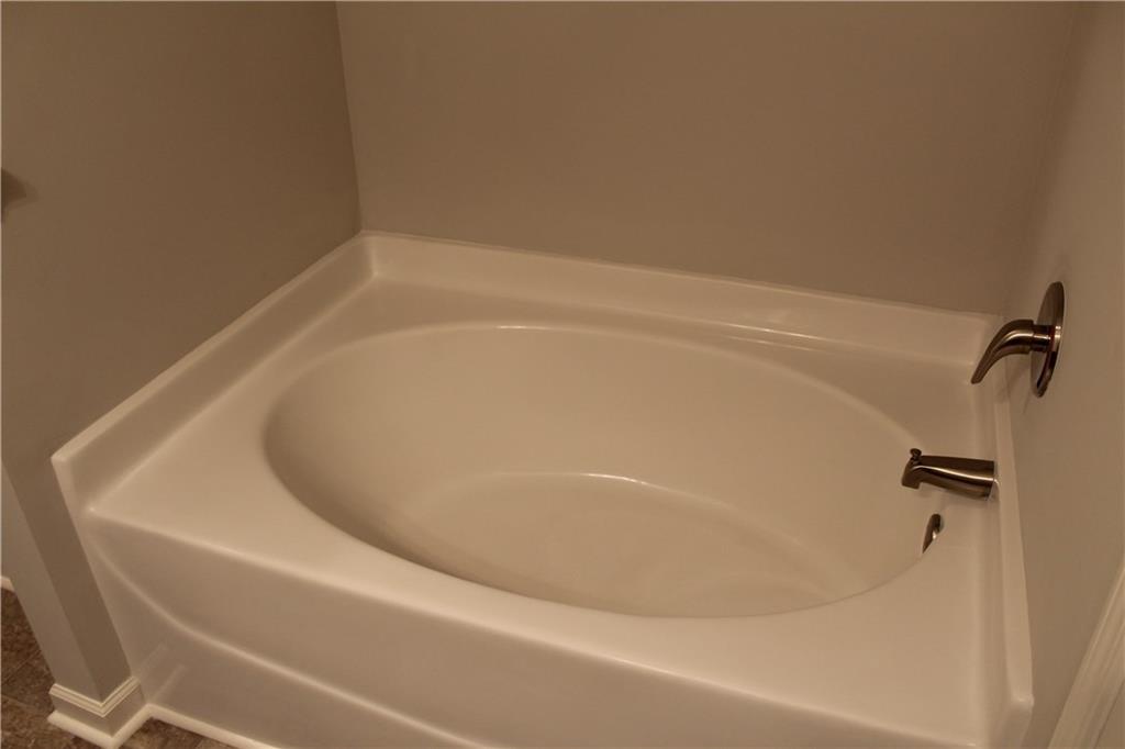 4741 Beacon Ridge Lane Flowery Branch, GA 30542 - Photo 10 of 15 a close up of a bathtub in a bathroom