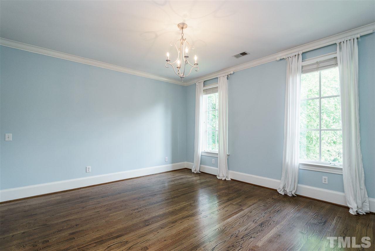 312 Forsyth Street Raleigh, NC 27609 - Photo 14 of 25 a view of an empty room with wooden floor and a window