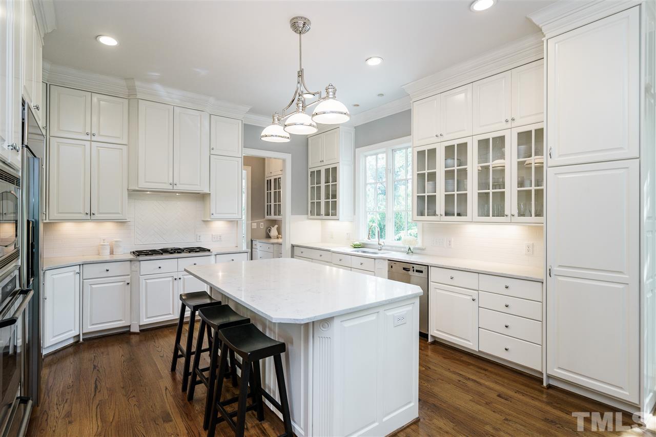 312 Forsyth Street Raleigh, NC 27609 - Photo 5 of 25 a kitchen with a stove a sink and a refrigerator