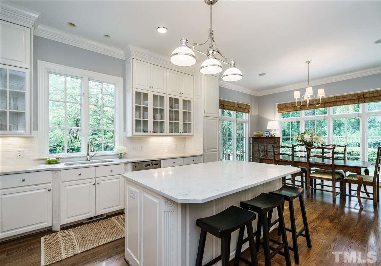 312 Forsyth Street Raleigh, NC 27609 - Photo 6 of 25 a kitchen with a table chairs and wooden floor