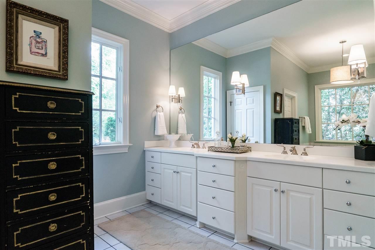 312 Forsyth Street Raleigh, NC 27609 - Photo 10 of 25 a bathroom with a double vanity sink and a window