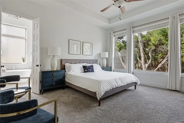 a spacious bedroom with a bed and a large window
