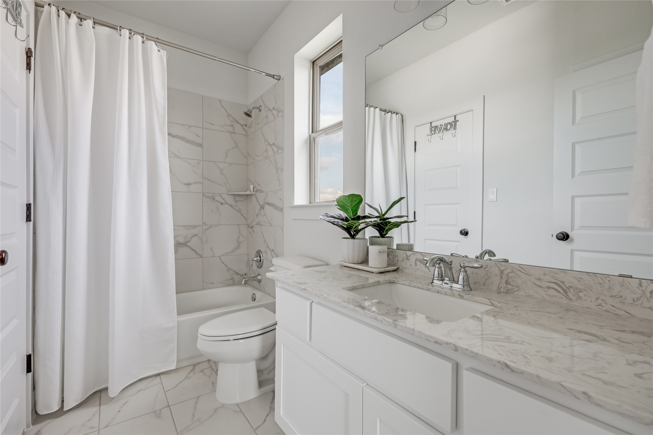 4905 Destination Way Jonestown, TX 78645 - Photo 18 of 27 a bathroom with a granite countertop sink a toilet and a large mirror