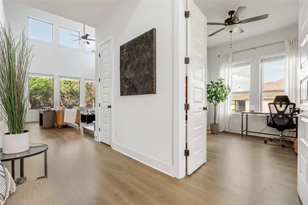 a view of a livingroom with furniture hardwood floor and a ceiling fan