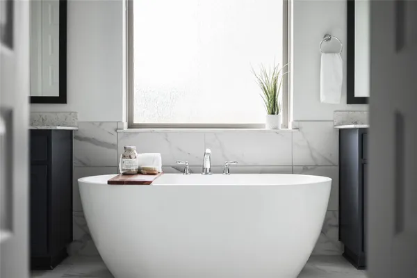 a white bath tub sitting in a bathroom