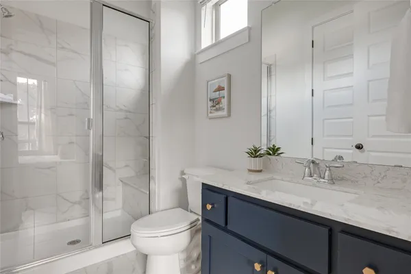a bathroom with a sink toilet and shower