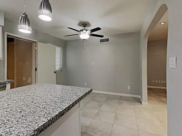 a view of a hallway with a chandelier fan