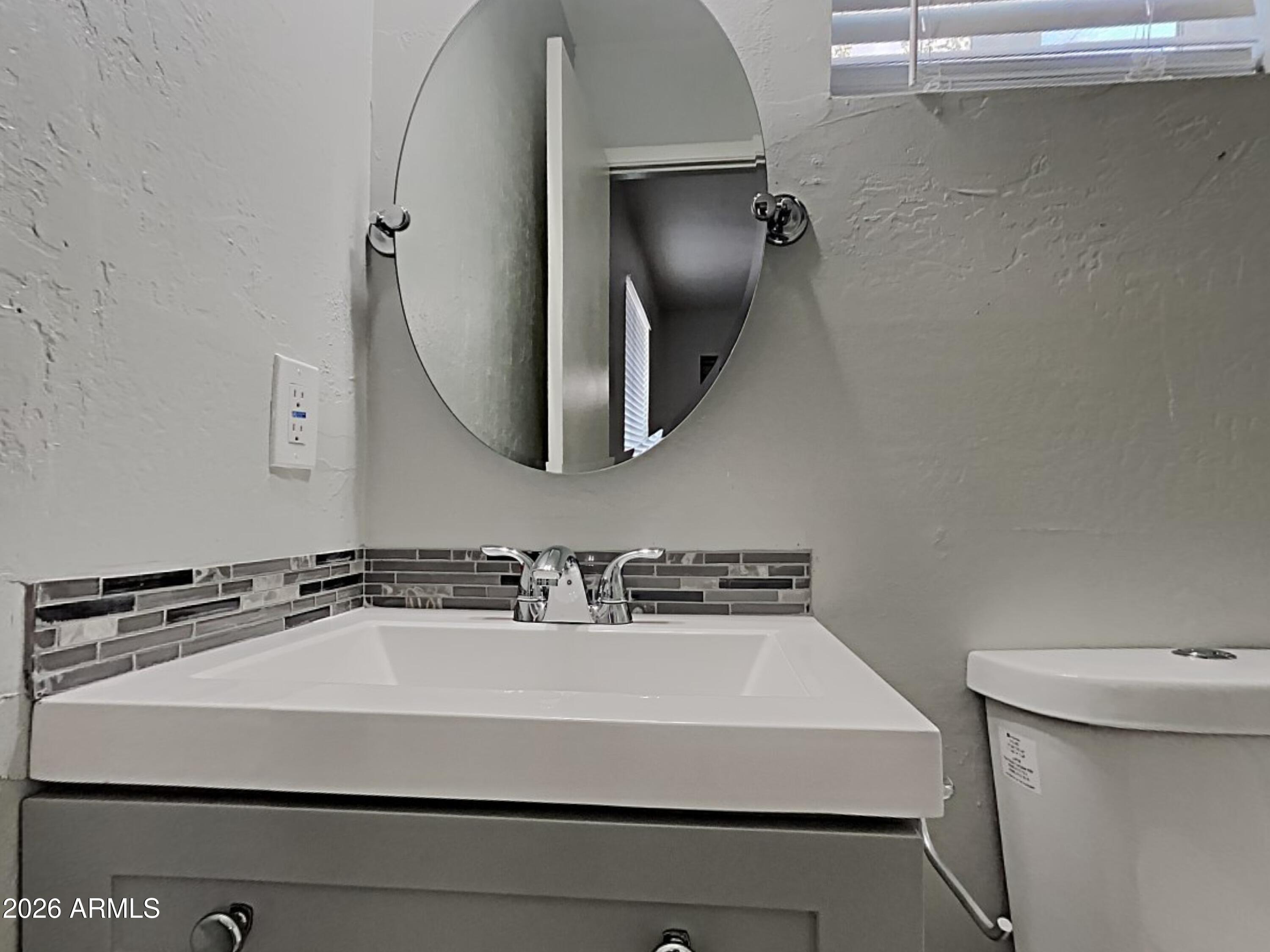 1001 West Villa Rita Drive Phoenix, AZ 85023 - Photo 13 of 26 a bathroom with a sink and a mirror