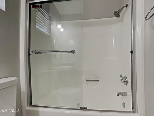 a bathroom with a glass shower door