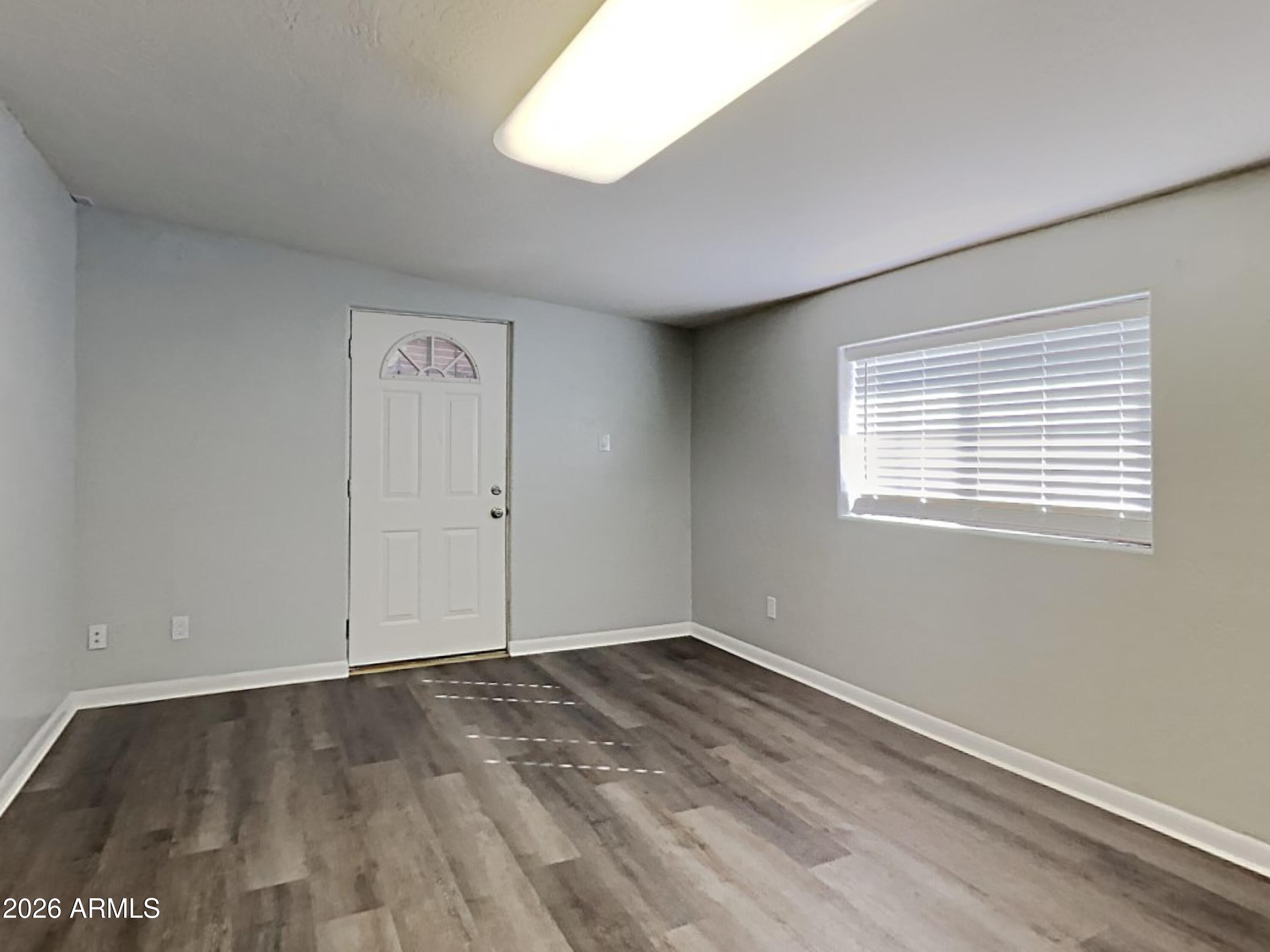 1001 West Villa Rita Drive Phoenix, AZ 85023 - Photo 20 of 26 an empty room with wooden floor and windows