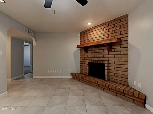 a view of an empty room with a fireplace