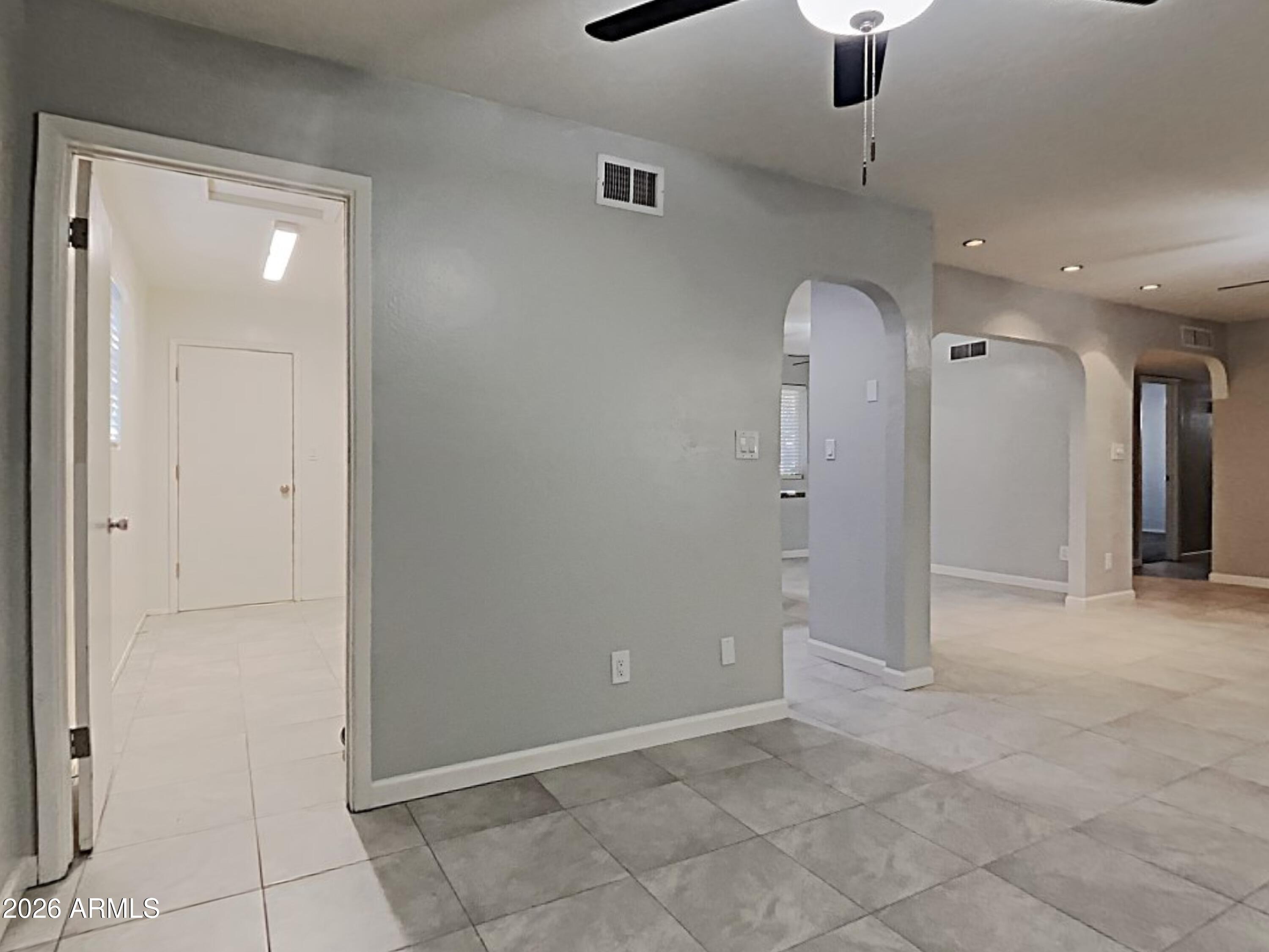1001 West Villa Rita Drive Phoenix, AZ 85023 - Photo 6 of 26 an empty room with fan and entrance