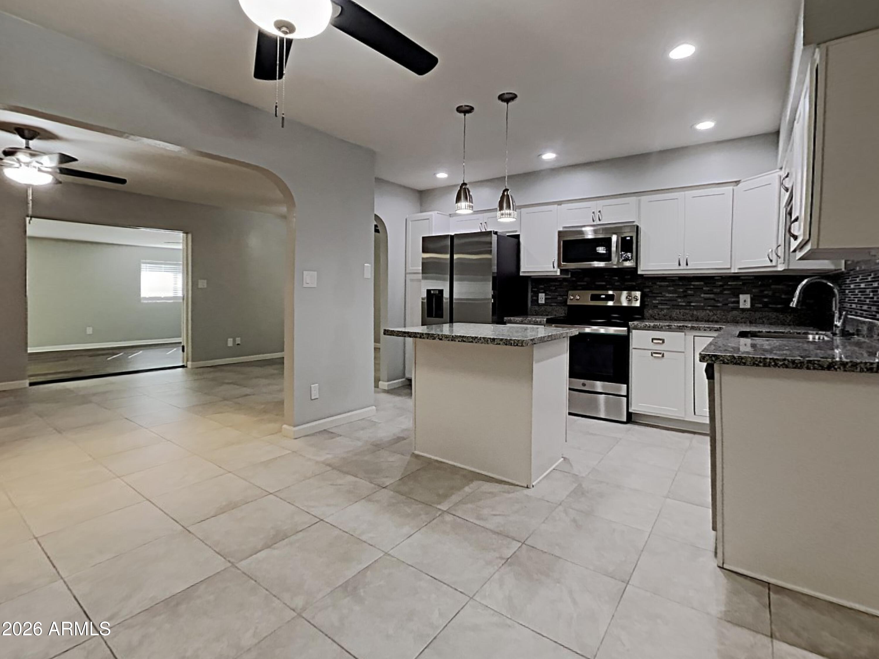 1001 West Villa Rita Drive Phoenix, AZ 85023 - Photo 8 of 26 a kitchen with stainless steel appliances granite countertop a sink and a stove