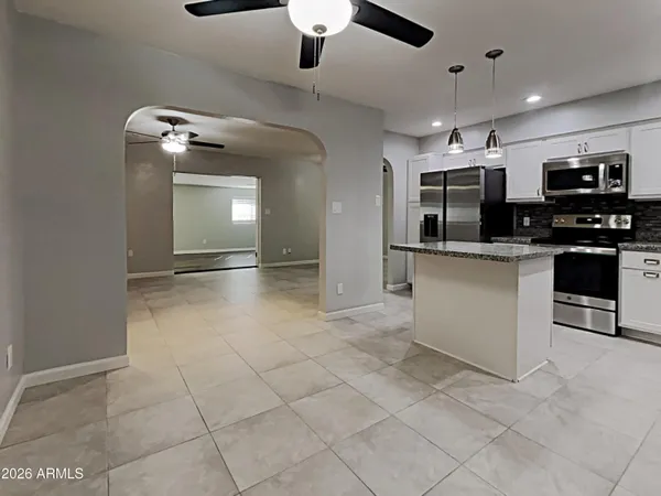 a kitchen with stainless steel appliances granite countertop a sink and a stove top oven