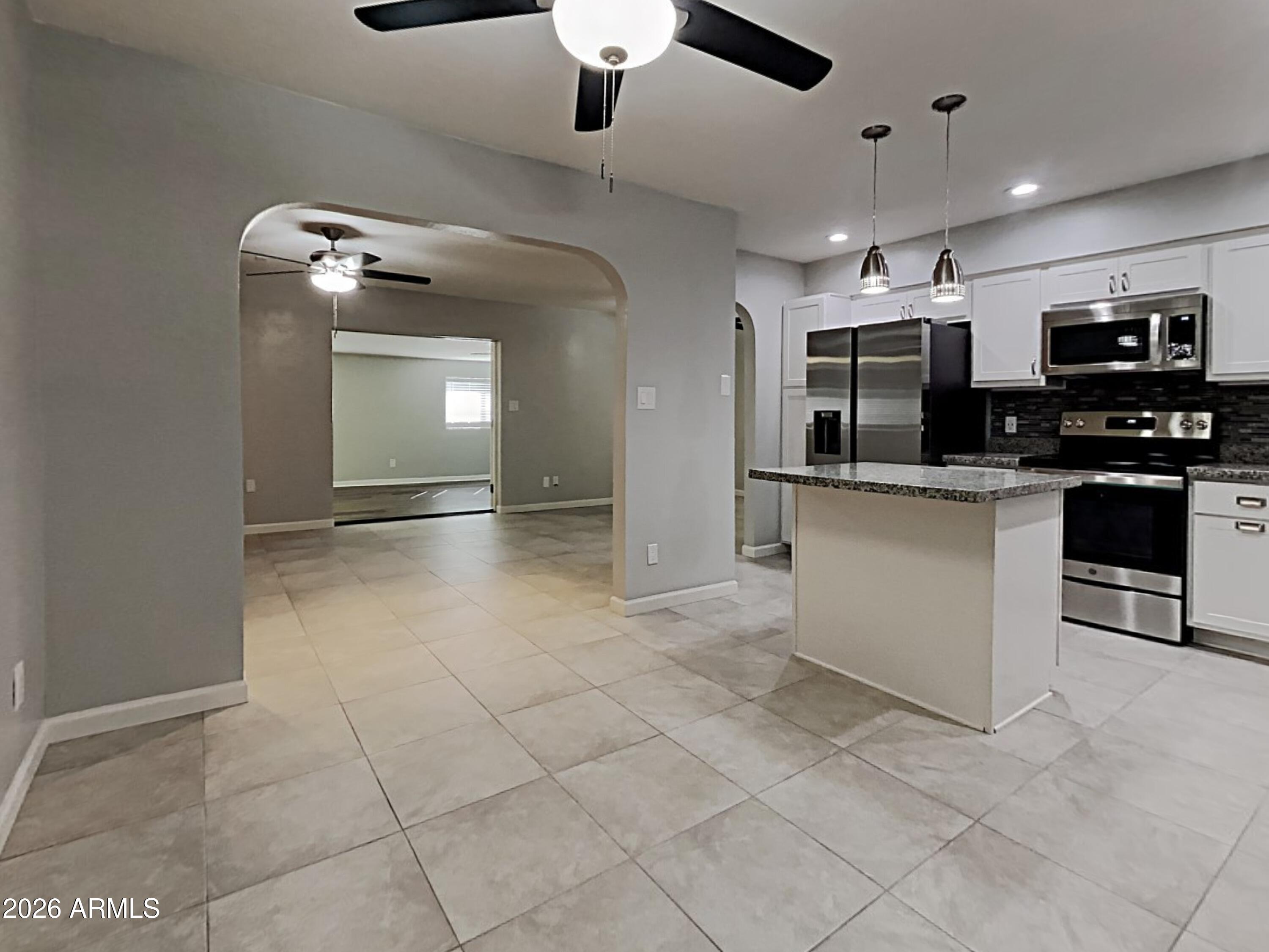 1001 West Villa Rita Drive Phoenix, AZ 85023 - Photo 9 of 26 a kitchen with stainless steel appliances granite countertop a sink and a stove top oven