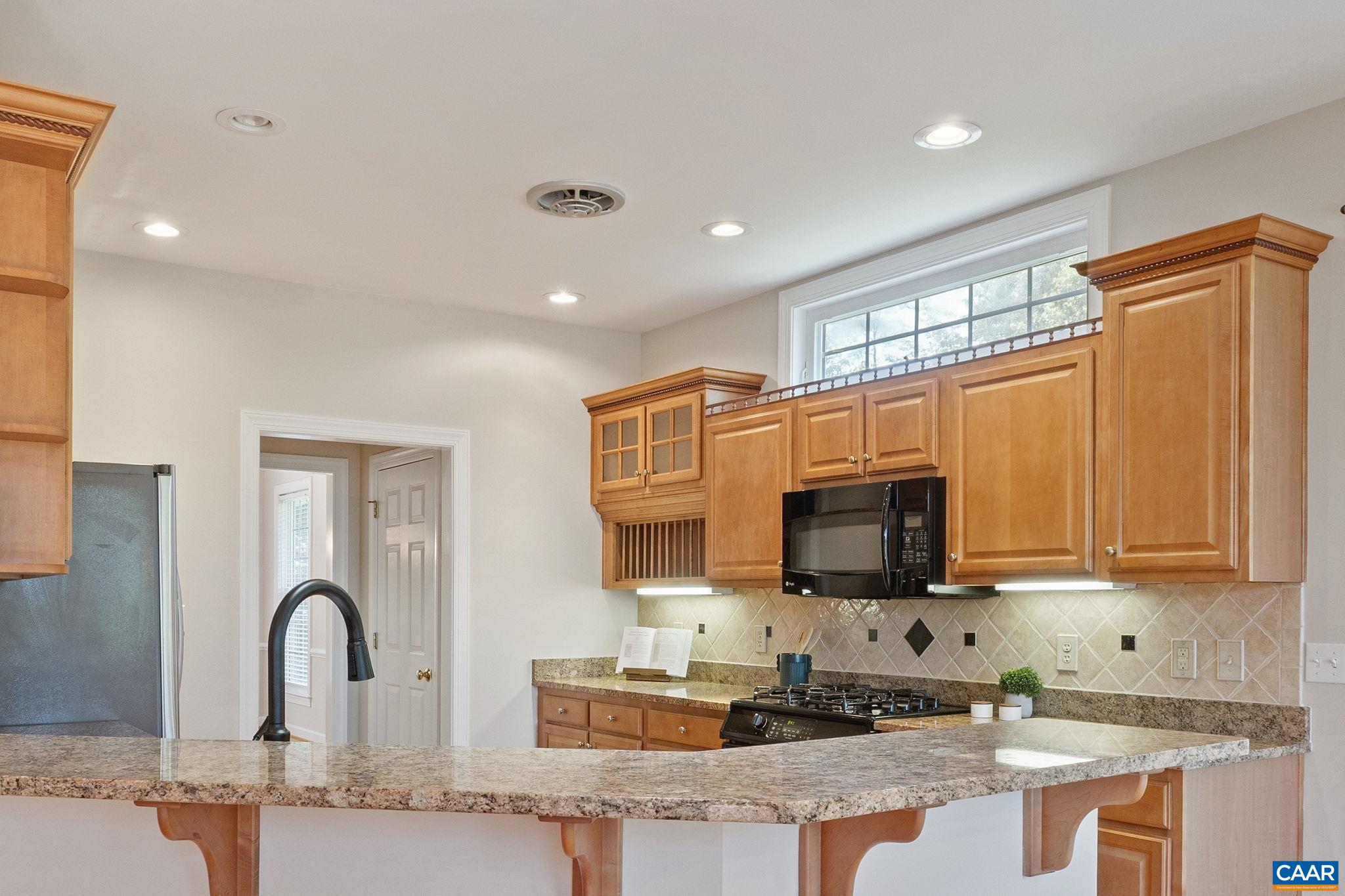 680 Explorers Road Charlottesville, VA 22911 - Photo 11 of 46 a kitchen with granite countertop a stove and a sink