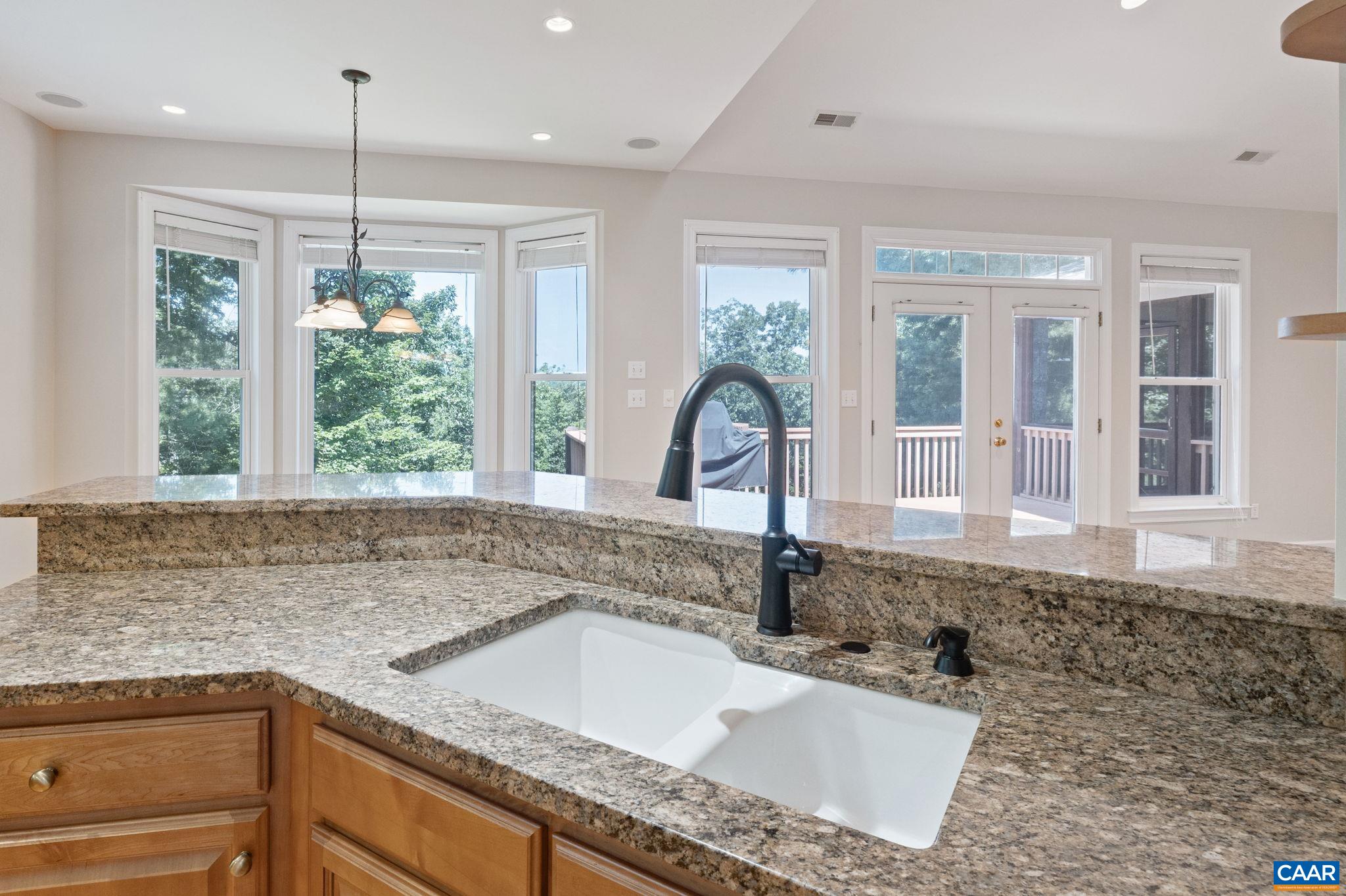 680 Explorers Road Charlottesville, VA 22911 - Photo 12 of 46 a kitchen with a granite countertop sink and natural light