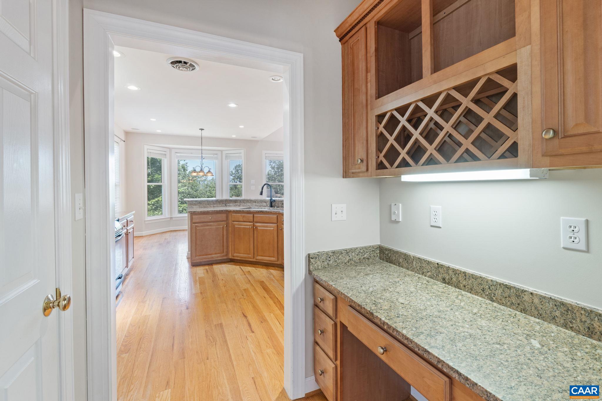 680 Explorers Road Charlottesville, VA 22911 - Photo 15 of 46 a kitchen with granite countertop a sink a stove and cabinets