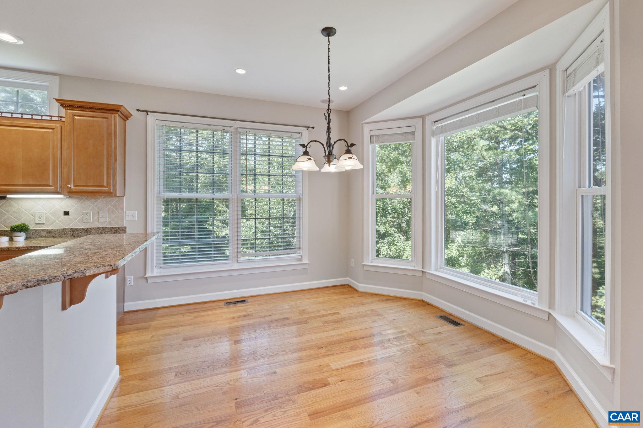 680 Explorers Road Charlottesville, VA 22911 - Photo 16 of 46 a view of a kitchen with wooden cabinets and outdoor space