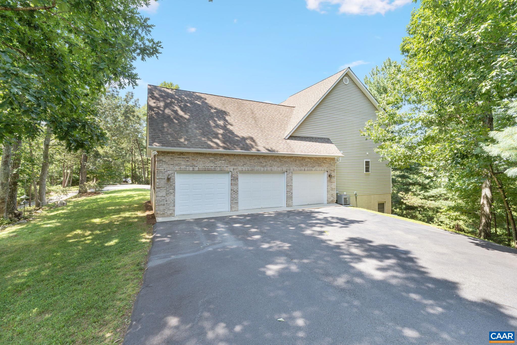 680 Explorers Road Charlottesville, VA 22911 - Photo 41 of 46 a front view of a house with a yard and garage