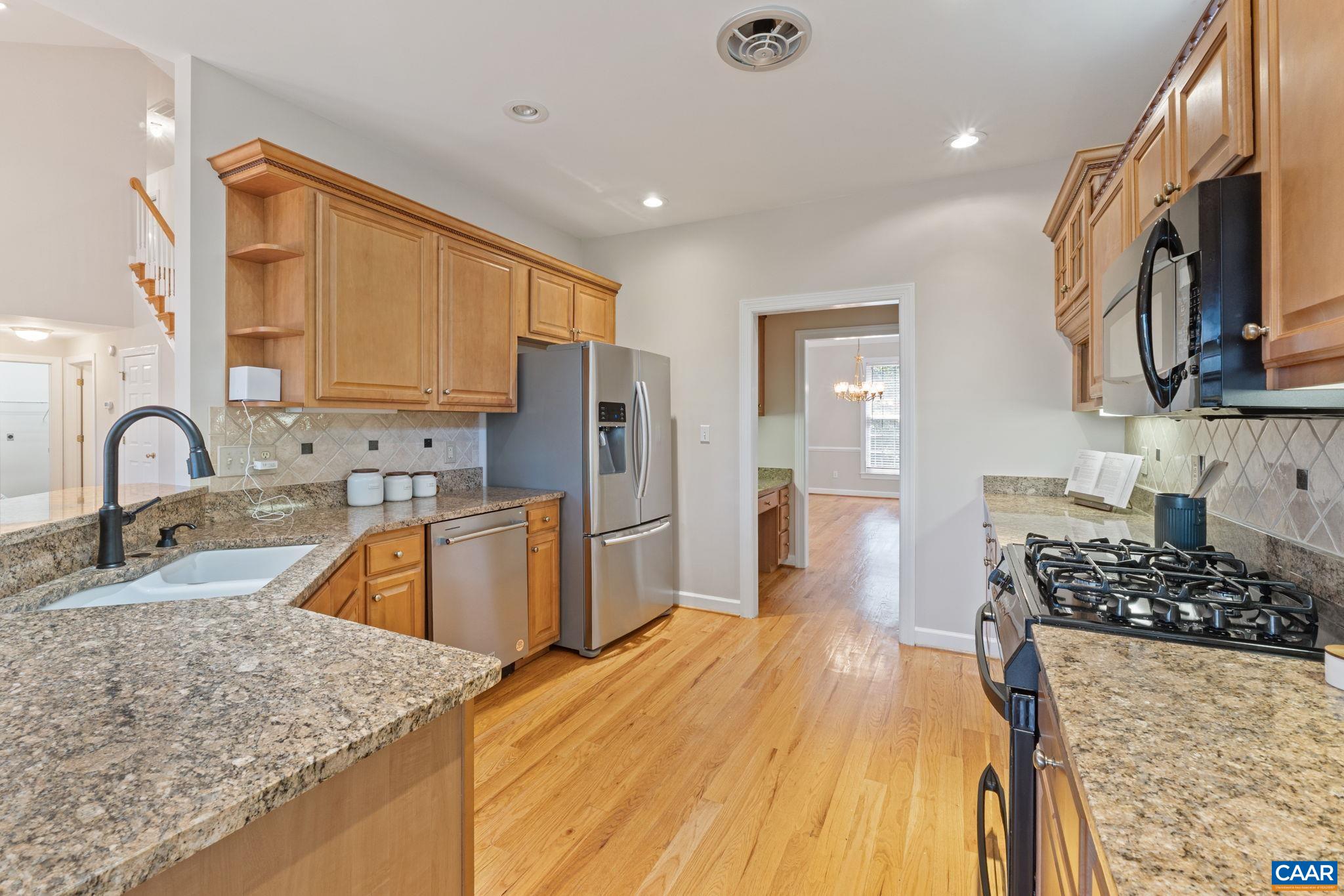 680 Explorers Road Charlottesville, VA 22911 - Photo 8 of 46 a kitchen with stainless steel appliances granite countertop a sink stove and refrigerator
