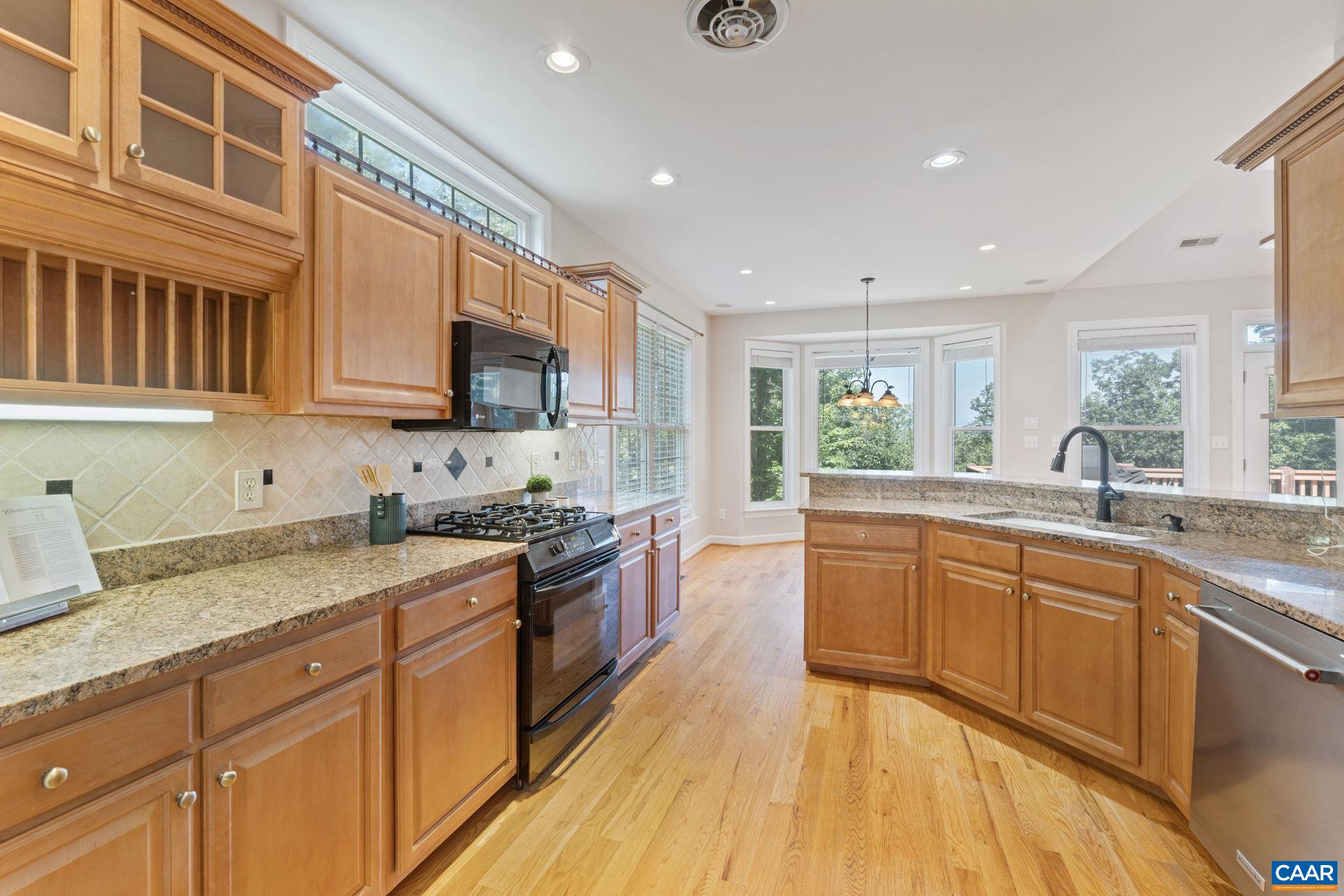 680 Explorers Road Charlottesville, VA 22911 - Photo 9 of 46 a large kitchen with stainless steel appliances granite countertop a stove sink and cabinets