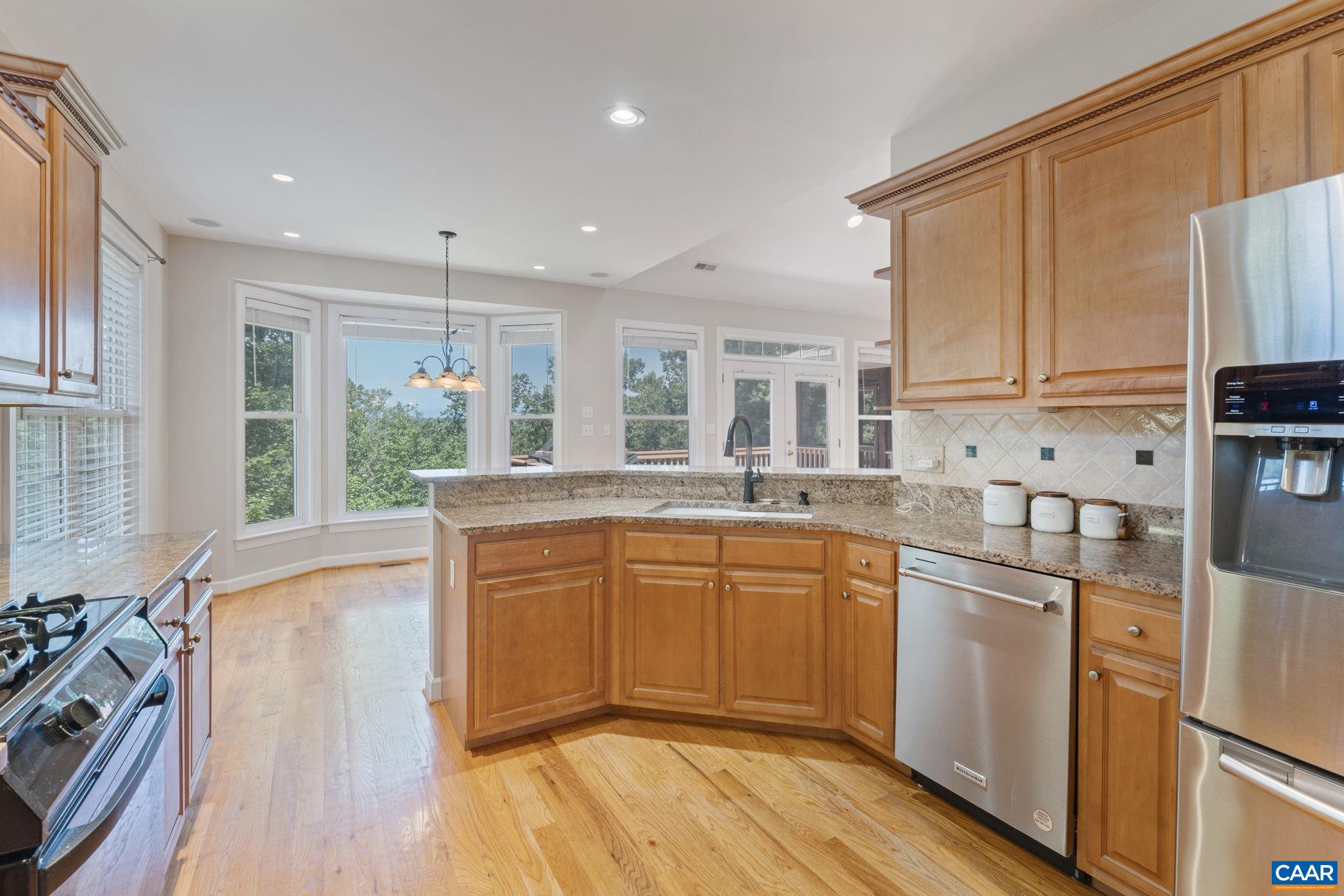 680 Explorers Road Charlottesville, VA 22911 - Photo 10 of 46 a kitchen with stainless steel appliances granite countertop a stove a sink dishwasher a refrigerator and white cabinets with wooden floor