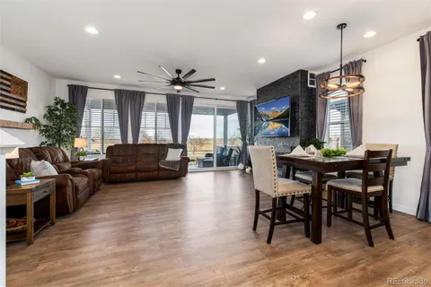 a kitchen with a table chairs refrigerator and cabinets