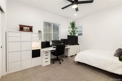 a bed room with a bed and a desk