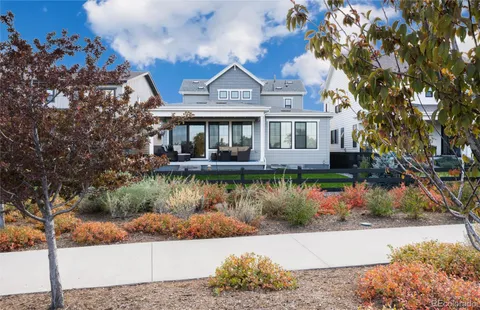 a kitchen with stainless steel appliances a dining table chairs and a refrigerator