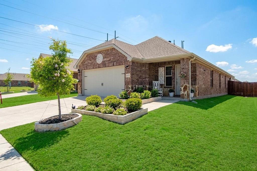 608 Daybreak Lane Lavon, TX 75166 - Photo 1 of 36 a front view of a house with a garden and plants