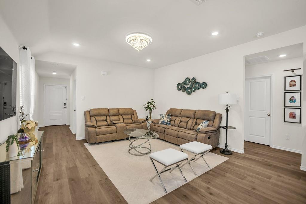 608 Daybreak Lane Lavon, TX 75166 - Photo 11 of 36 a living room with furniture and a wooden floor