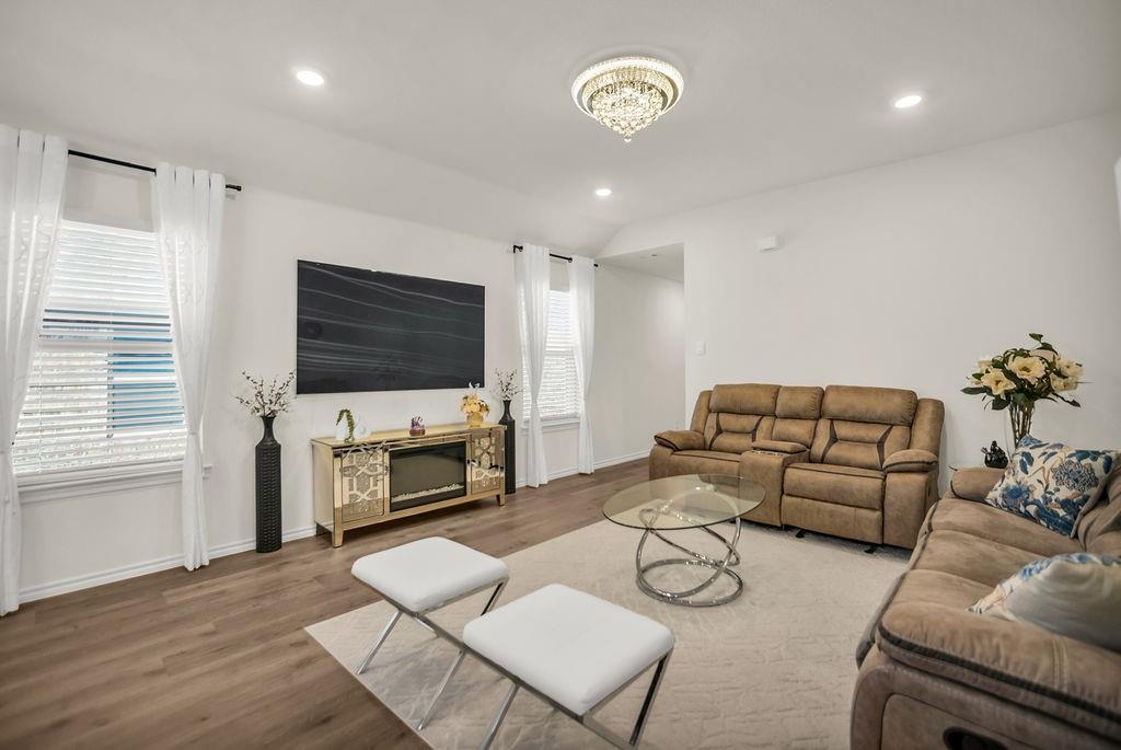 608 Daybreak Lane Lavon, TX 75166 - Photo 12 of 36 a living room with furniture flat screen tv and a fireplace