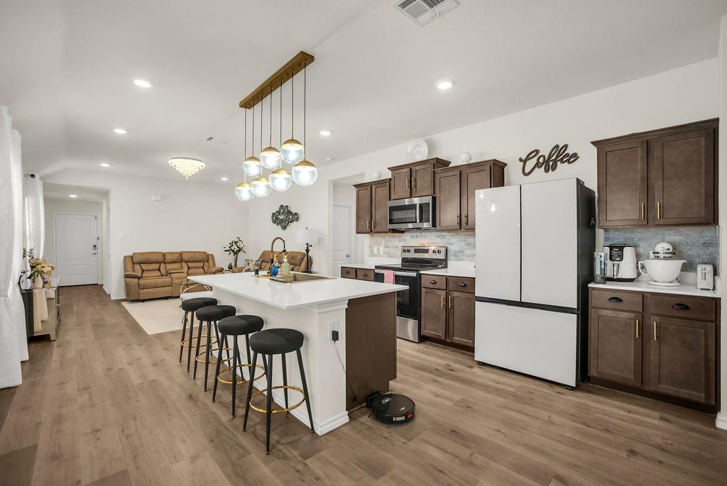 608 Daybreak Lane Lavon, TX 75166 - Photo 14 of 36 a kitchen with a center island appliances and cabinets