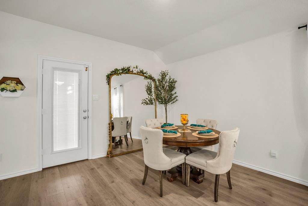 608 Daybreak Lane Lavon, TX 75166 - Photo 18 of 36 a view of a dining room with furniture and wooden floor