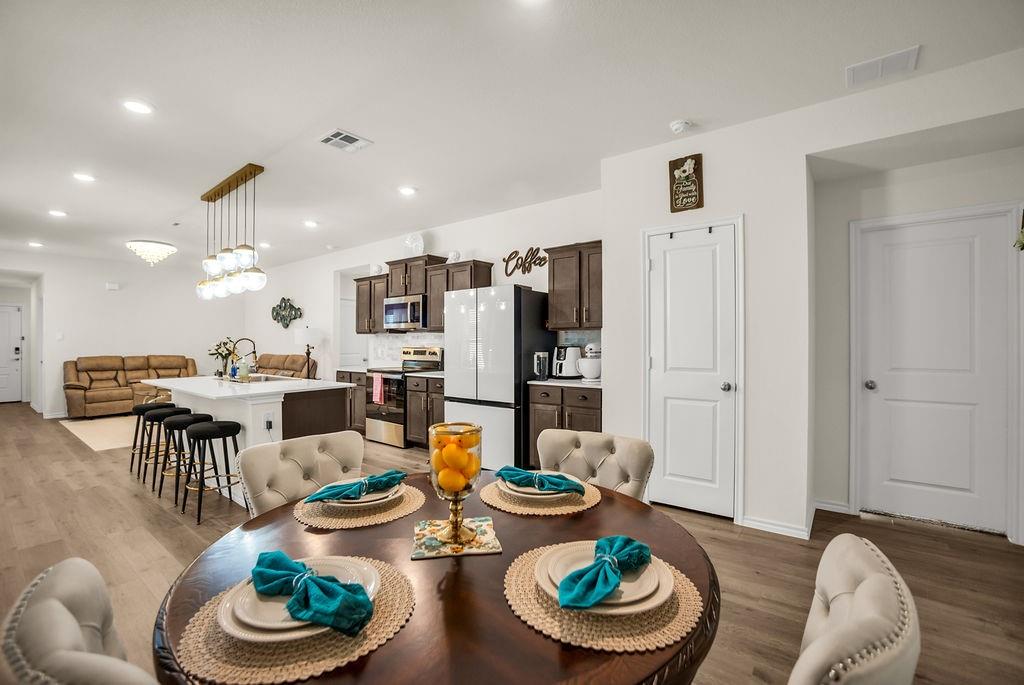 608 Daybreak Lane Lavon, TX 75166 - Photo 19 of 36 a room with stainless steel appliances couches chairs and kitchen view