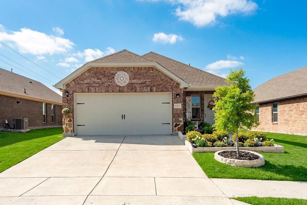 608 Daybreak Lane Lavon, TX 75166 - Photo 2 of 36 a front view of a house with garden