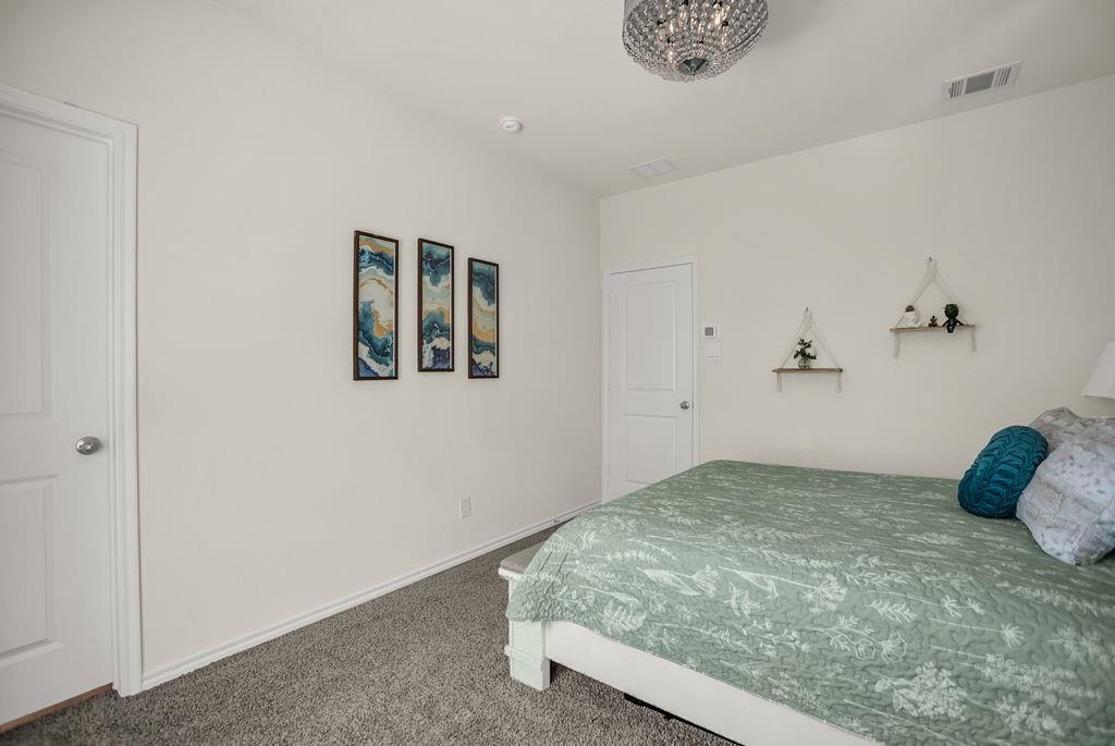608 Daybreak Lane Lavon, TX 75166 - Photo 21 of 36 a bedroom with a bed and a window